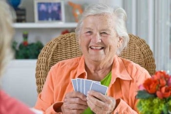 Senior medical alert client playing cards.